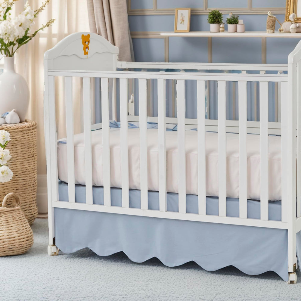 Brandream scallop edge crib skirt in mist blue enhances nursery elegance and tidies under-crib space.