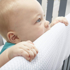 BreathableBaby long-panel on crib rail shows easy fit with hook-and-loop closure.