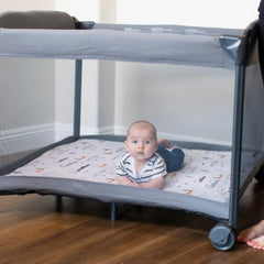 BROLEX Convertible playard mattress cover fitted on a travel bed.