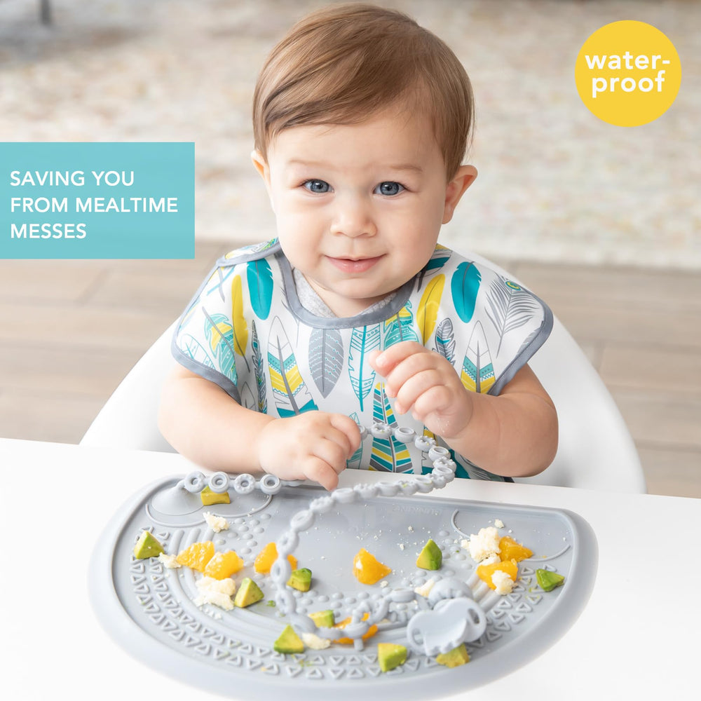 Bumkins SuperBib crumb catcher pocket helps catch spills.