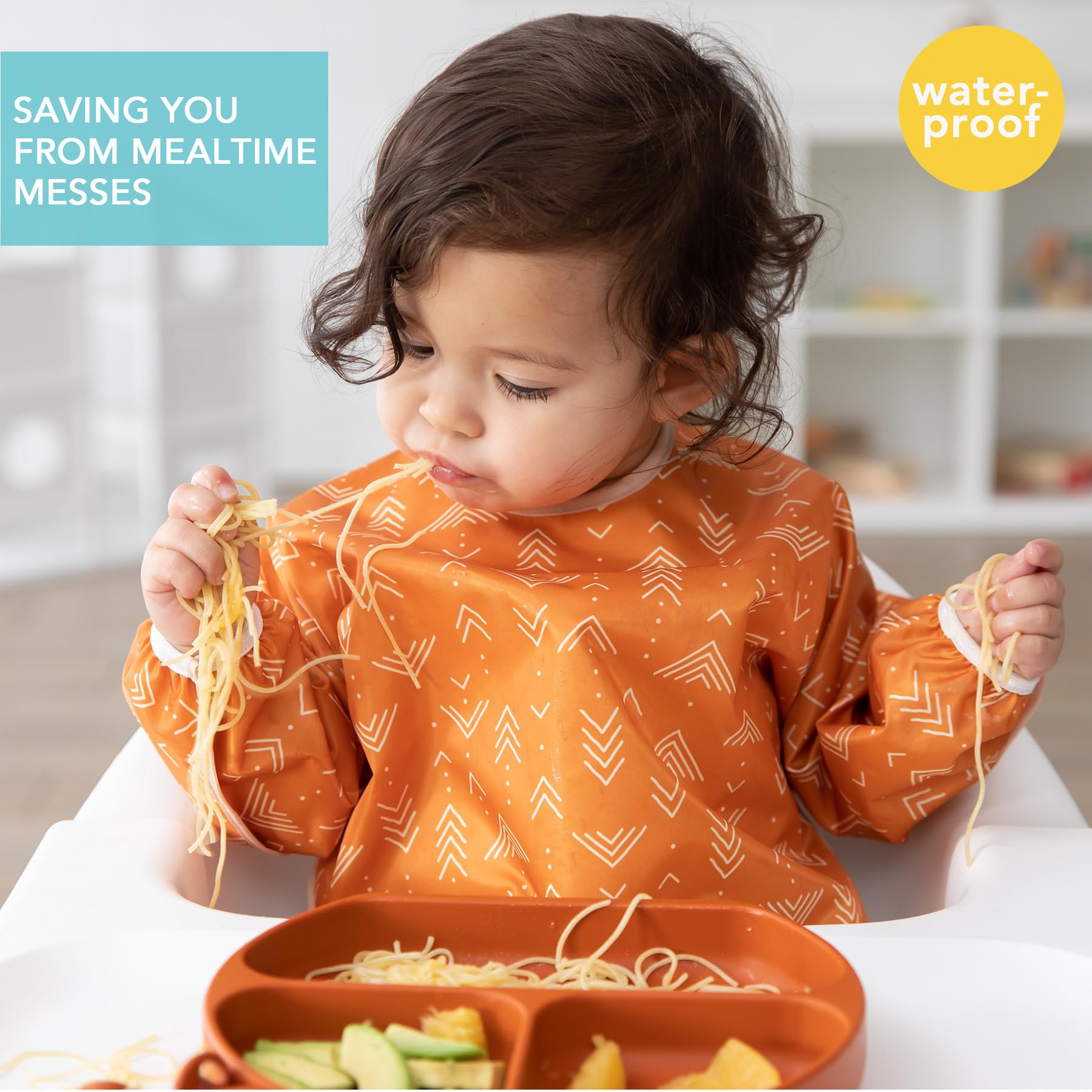 Bumkins Sleeved Bib Boho Orange back closure keeps straps secure during feeding.