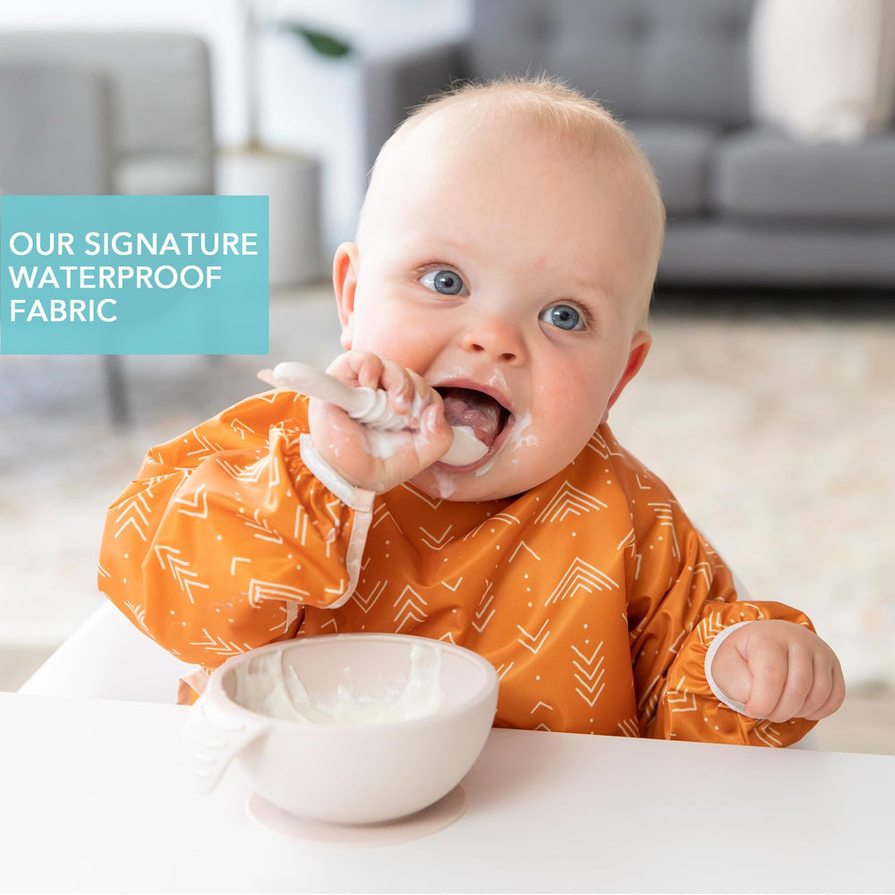 Bumkins Sleeved Bib Boho Orange crumb catcher pocket catches spills for easier cleanup.