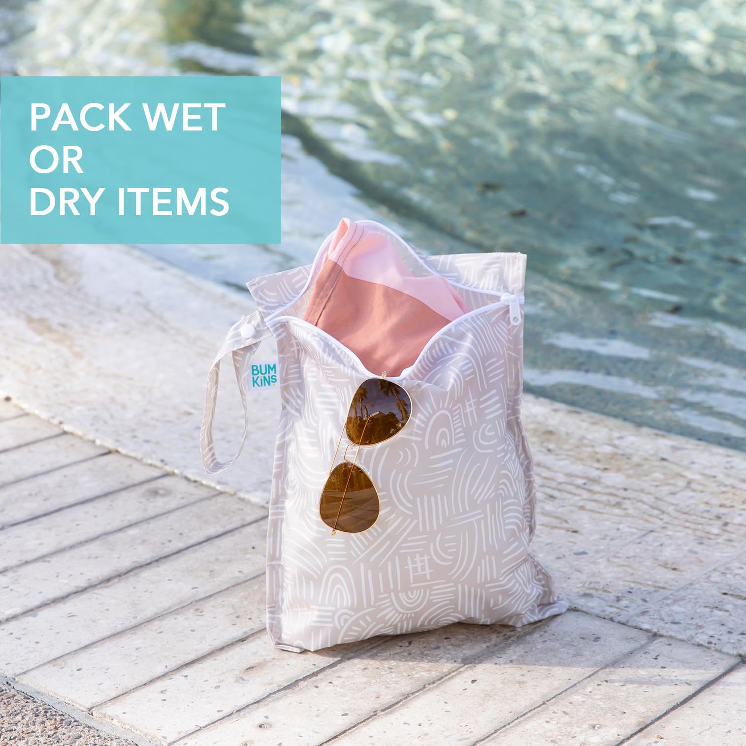 Bumkins Desert Boho wet bag on stroller clip for on-the-go storage.