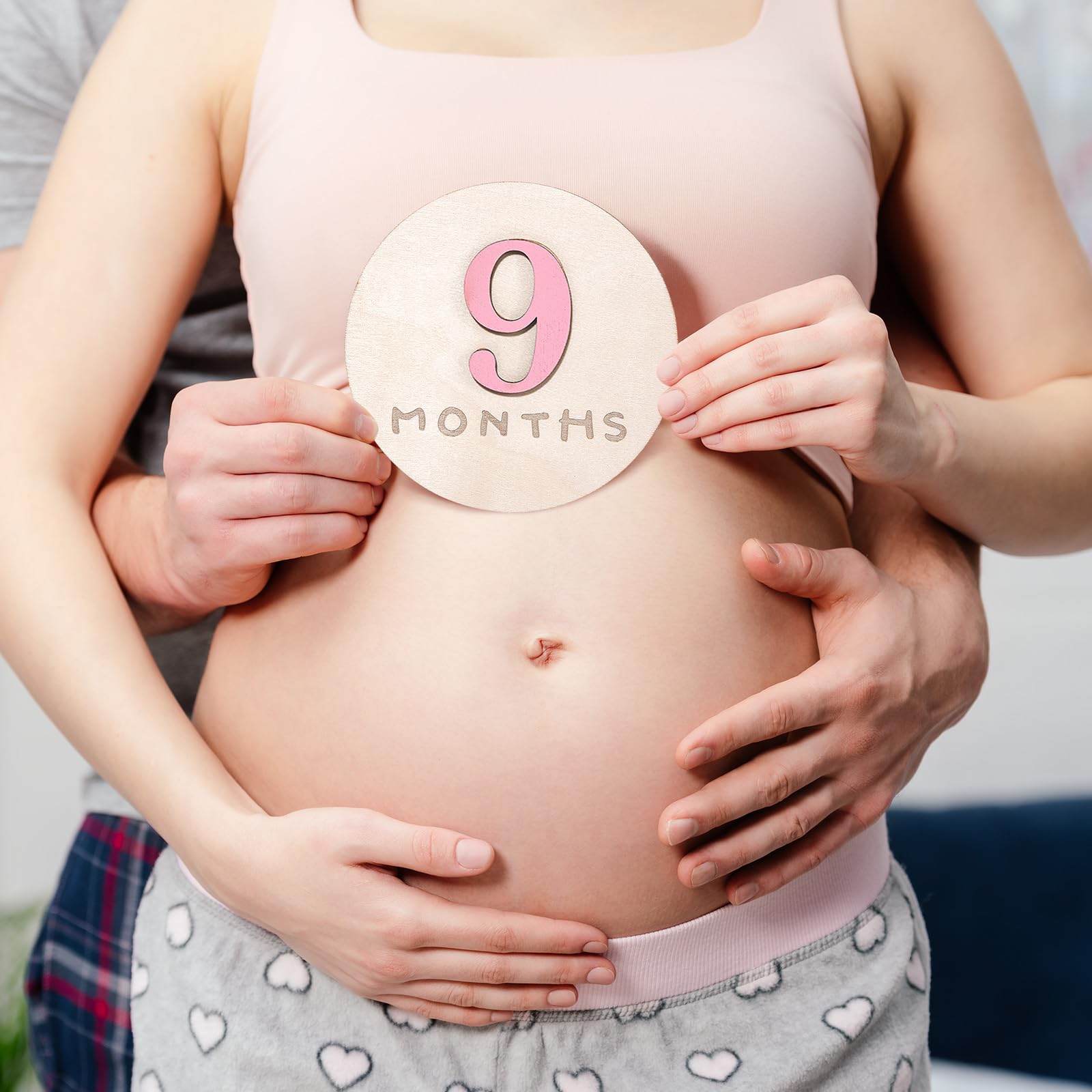Burbell pink wooden disc adds natural texture to nursery decor and photos