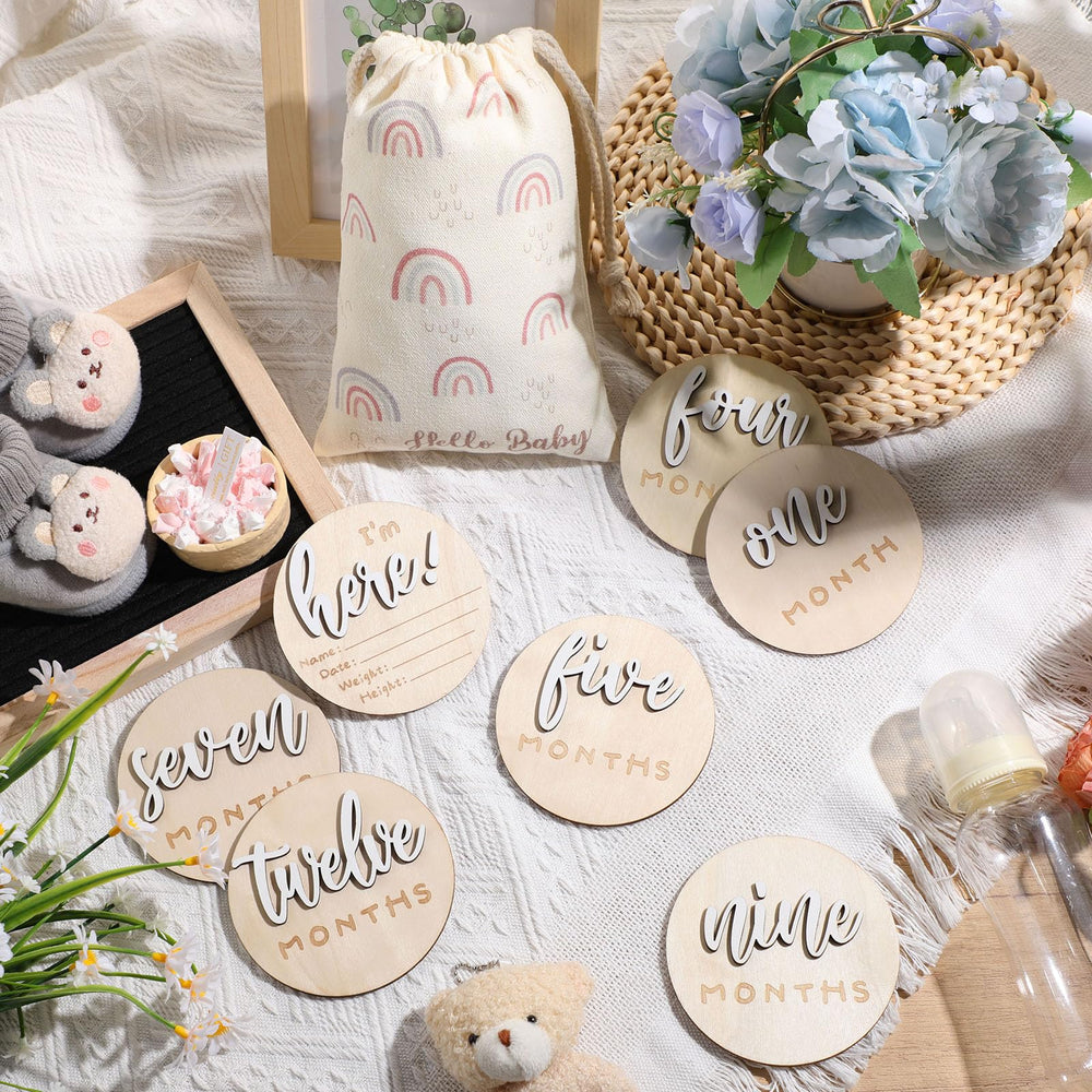 Burbell double-sided milestone discs showing months and Hello World for photo props.