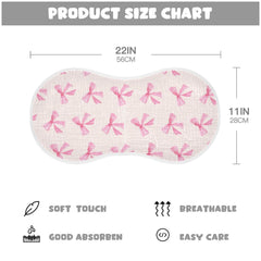 Burbuja pink bow muslin burp cloth folded neatly, showcasing compact storage.