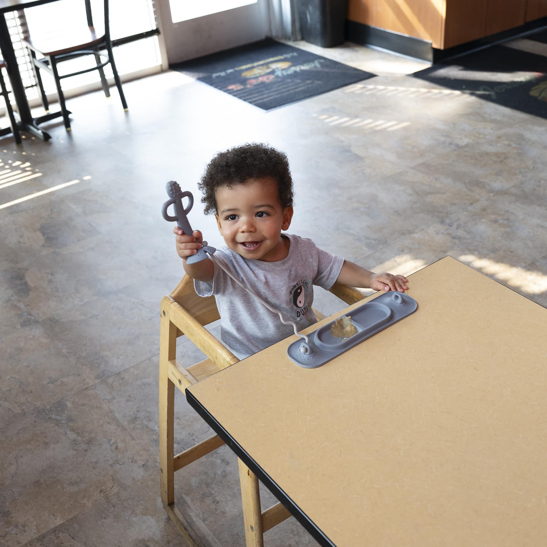 Busy Baby Mini Mat supports self-feeding and mess containment during meals.