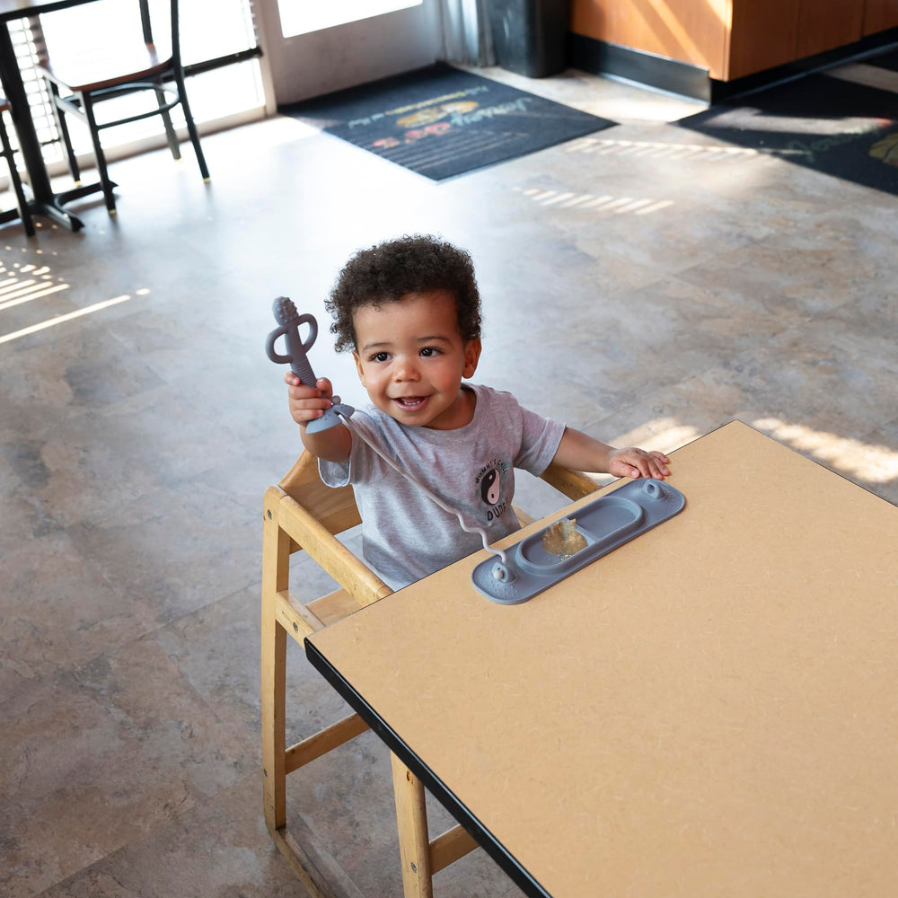Busy Baby Mini Mat supports self-feeding and mess containment during meals.