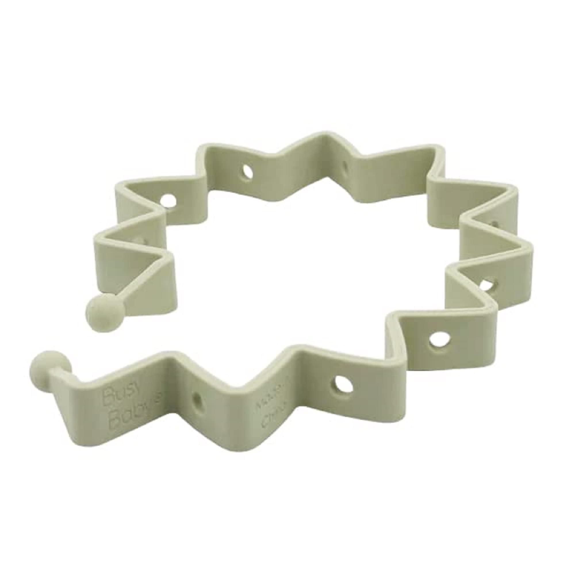 Busy Baby Toy Bungee in tan silicone keeps toys within reach on the mat.