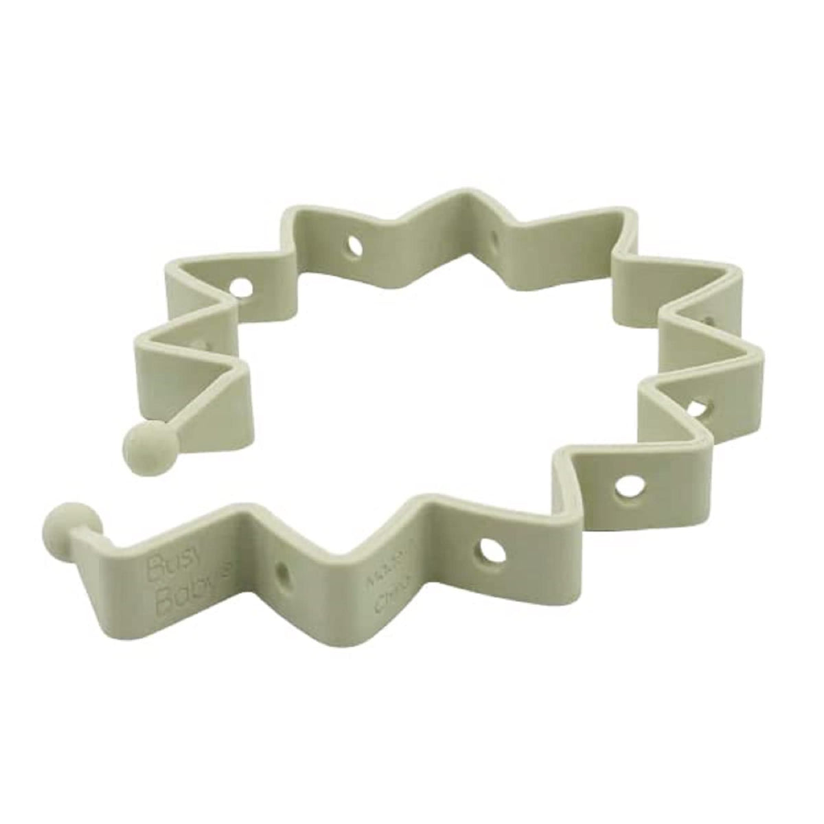 Busy Baby Toy Bungee in tan silicone keeps toys within reach on the mat.