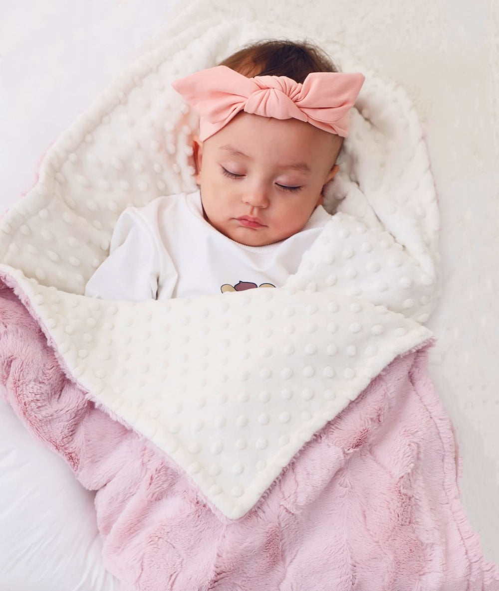 Buttzo baby blanket in nursery provides soft warmth during cuddle time.