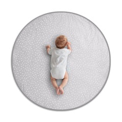 Byrd & Blume Round Baby Play Mat in gray fabric for gentle tummy time on soft surface.