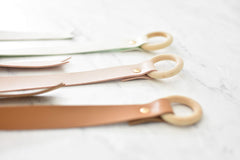 California Tot wooden ring detail highlights natural finishing on the organizers.
