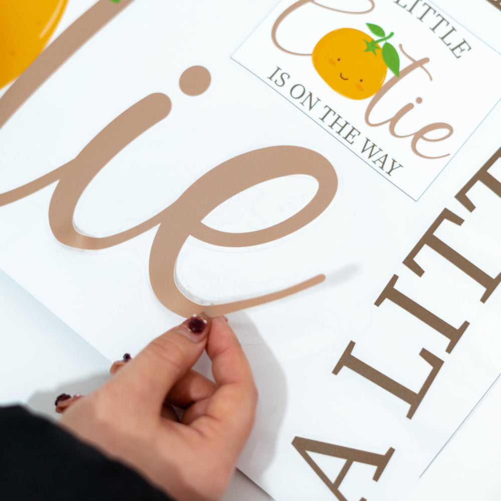 CANTLY A Little Cutie Is On The Way orange backdrop wall décor.