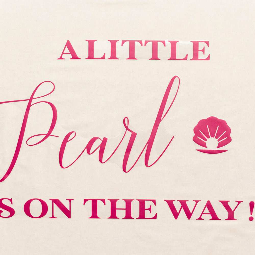 Capiont A Little Pearl decal used as photo backdrop for gender reveal