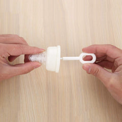 Caralin nipple brush shown cleaning the top edge of a nipple.