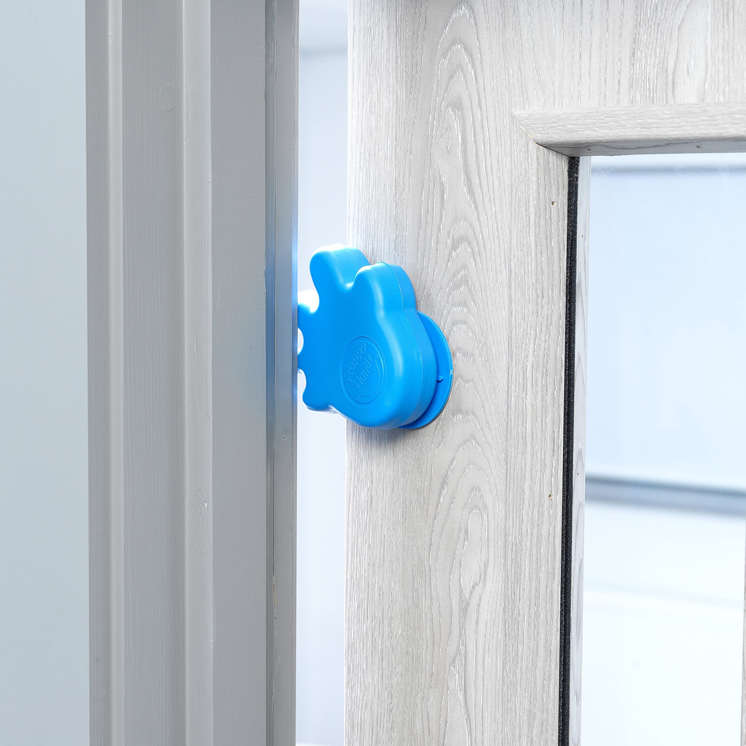 Cardea Solutions Happy Hands blue door stopper side view showing slim protection.