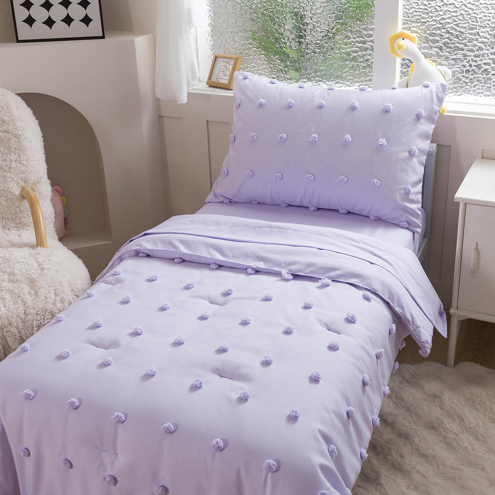 Caressma lavender-pom-pom comforter adds playful texture for cozy nights.