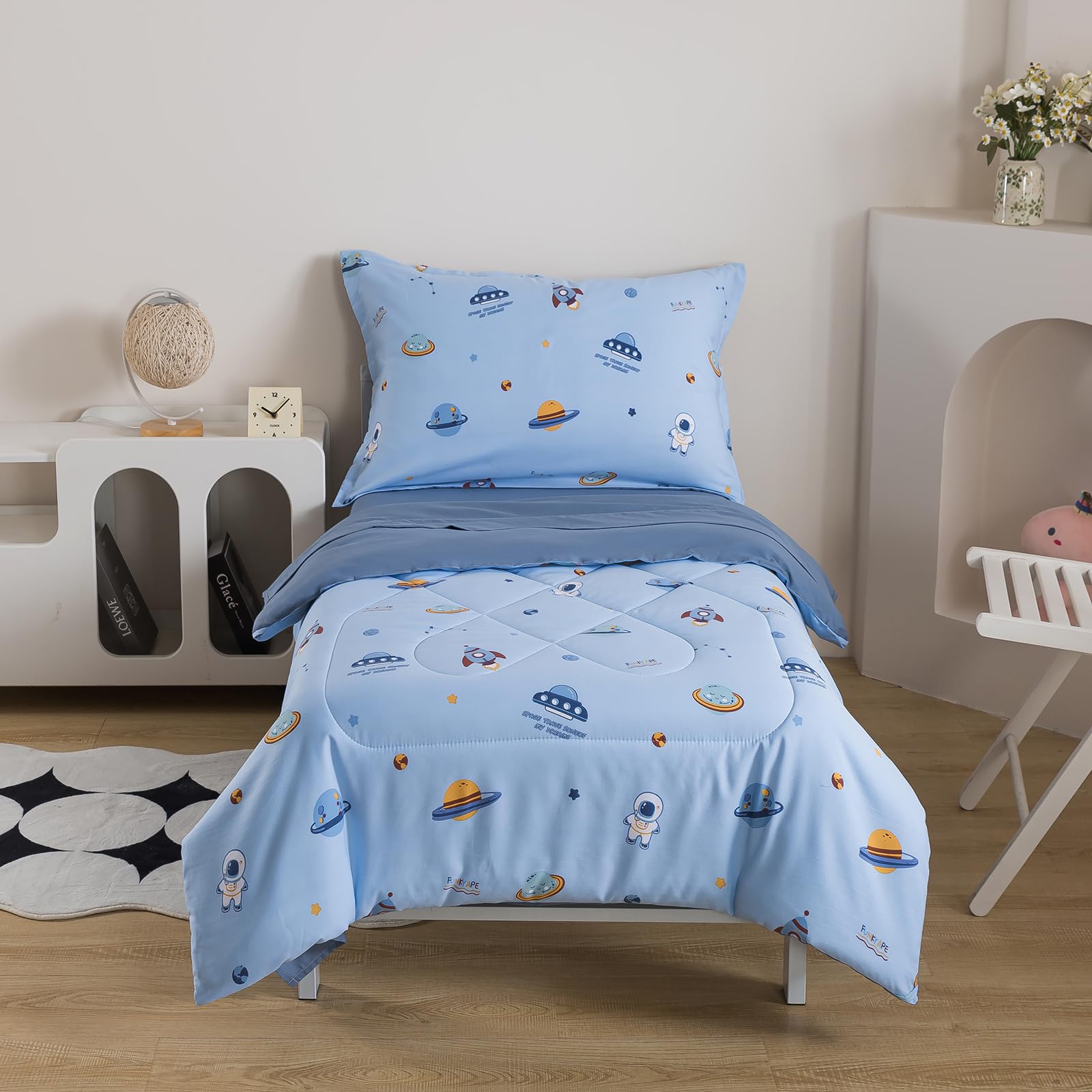 Caressma spaceship comforter 42x58 on a toddler bed offers cozy warmth and style.