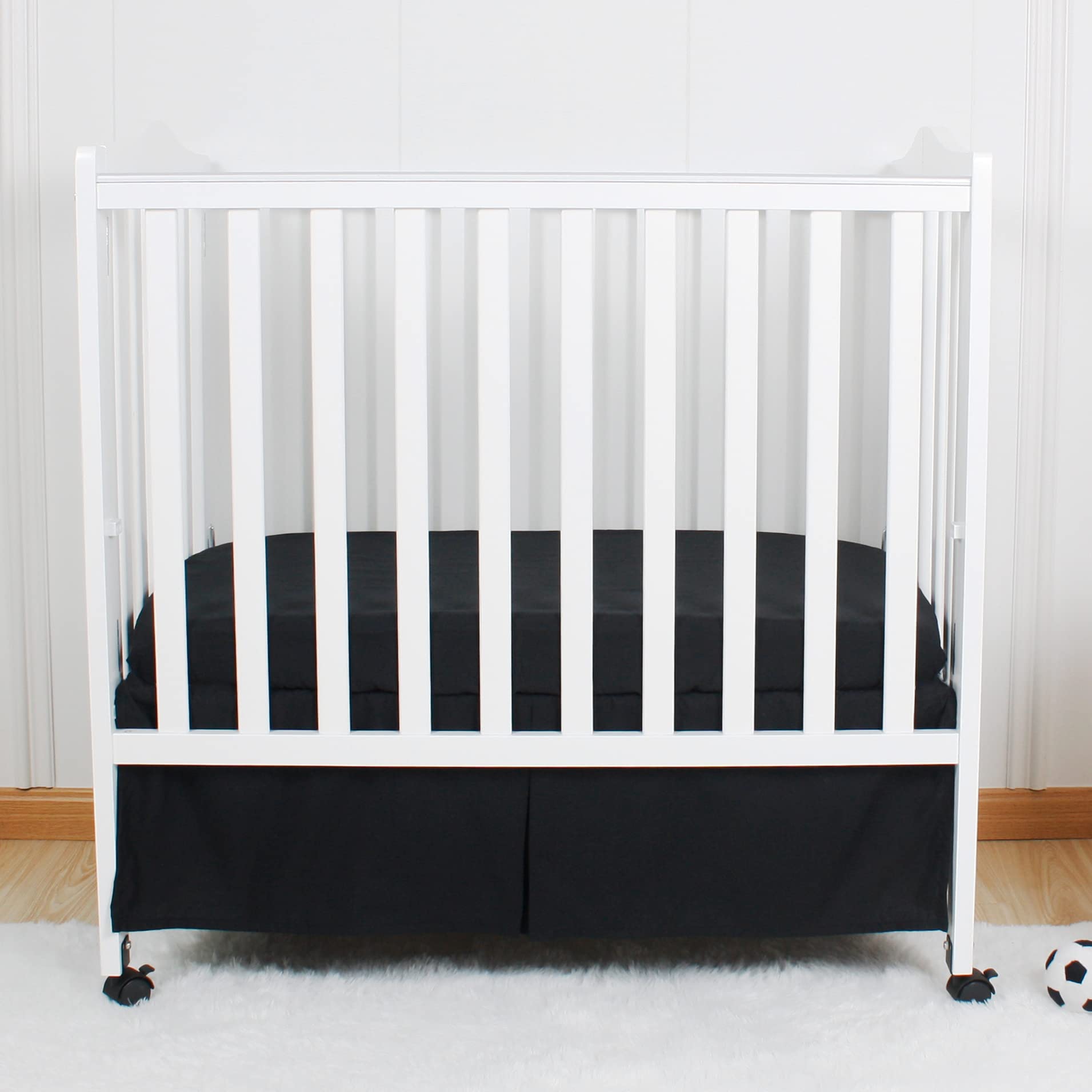 CaSaJa mini pleated black crib skirt with 12-inch drop.