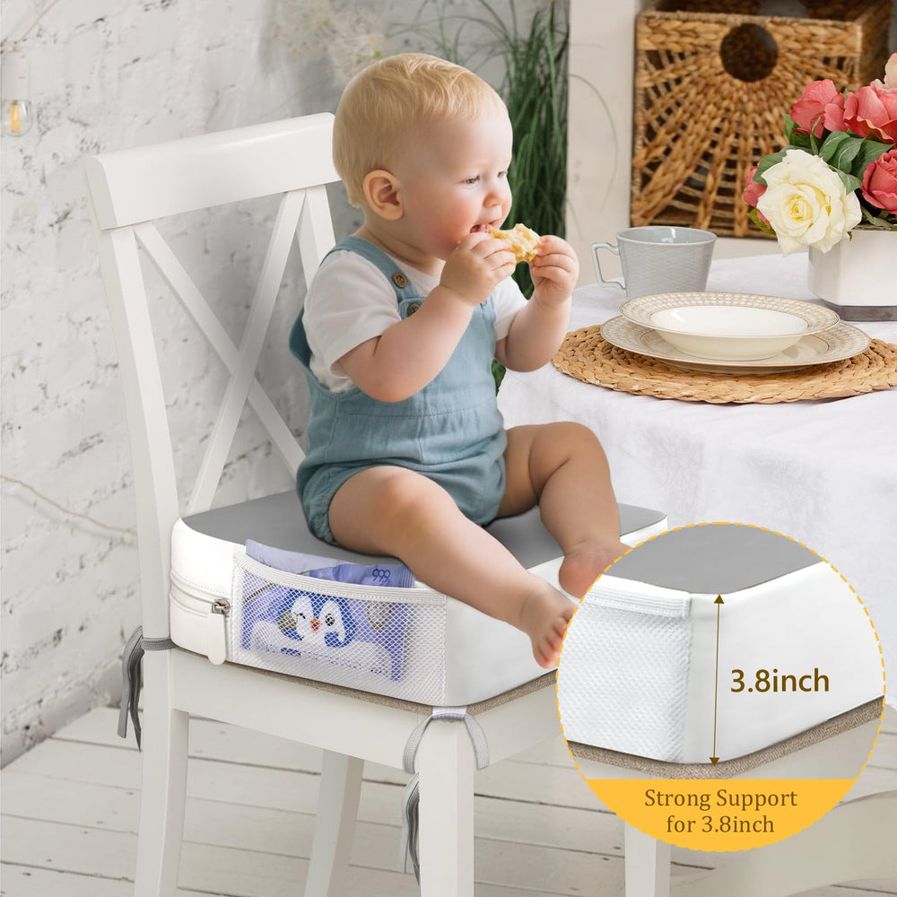 CAVWVTYU booster seat with side pockets for wipes and toys.