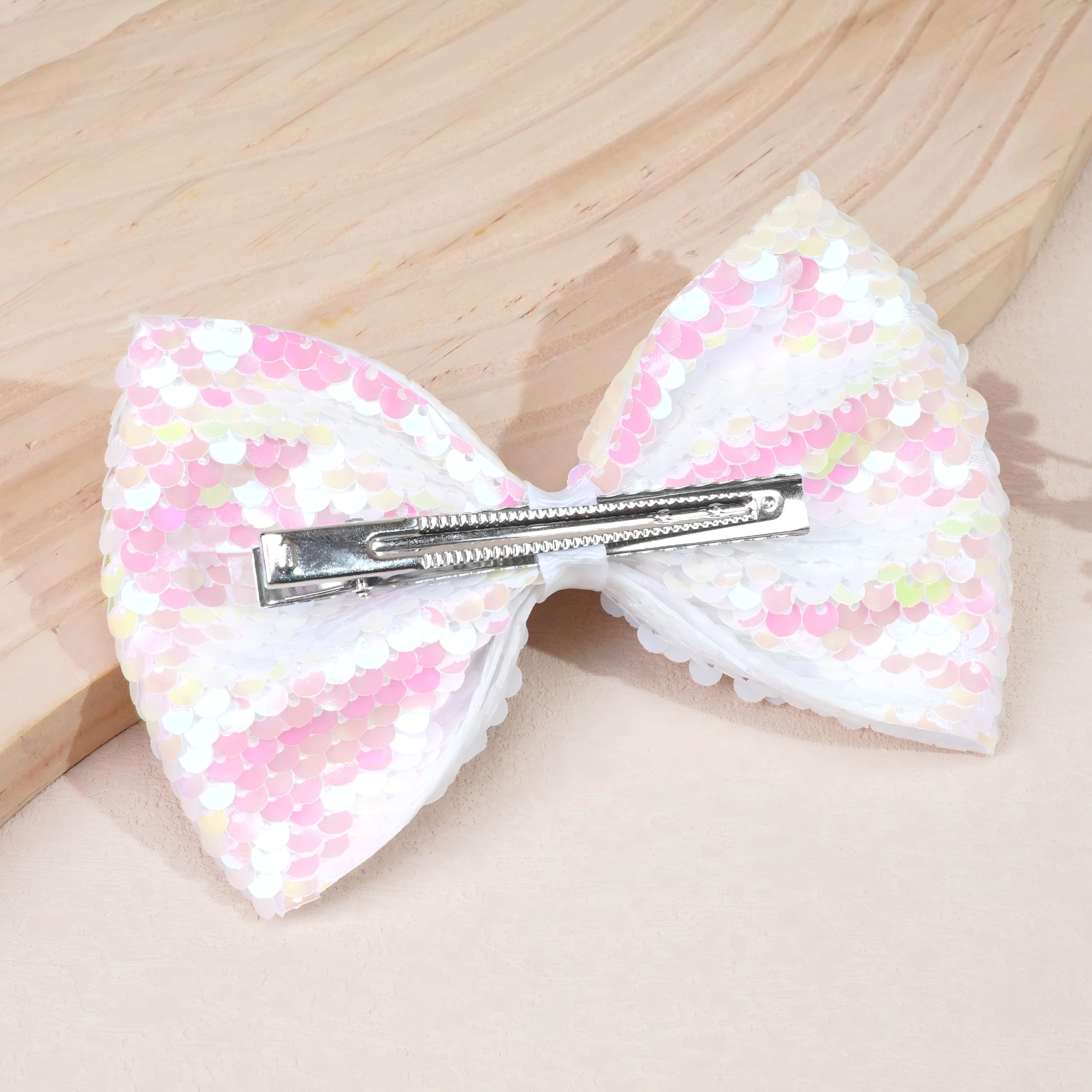 CÉLLOT glitter bow hair clip worn by toddlers for charming dress-up moments.