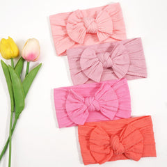 CÉLLOT baby hair accessory headband with bows; soft, easy-to-wear.
