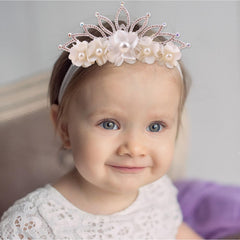 cherrboll baby wearing flower headband demonstrates secure fit without slipping.