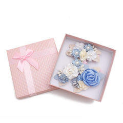 Cherrboll ivory rose clip complements newborn outfits.