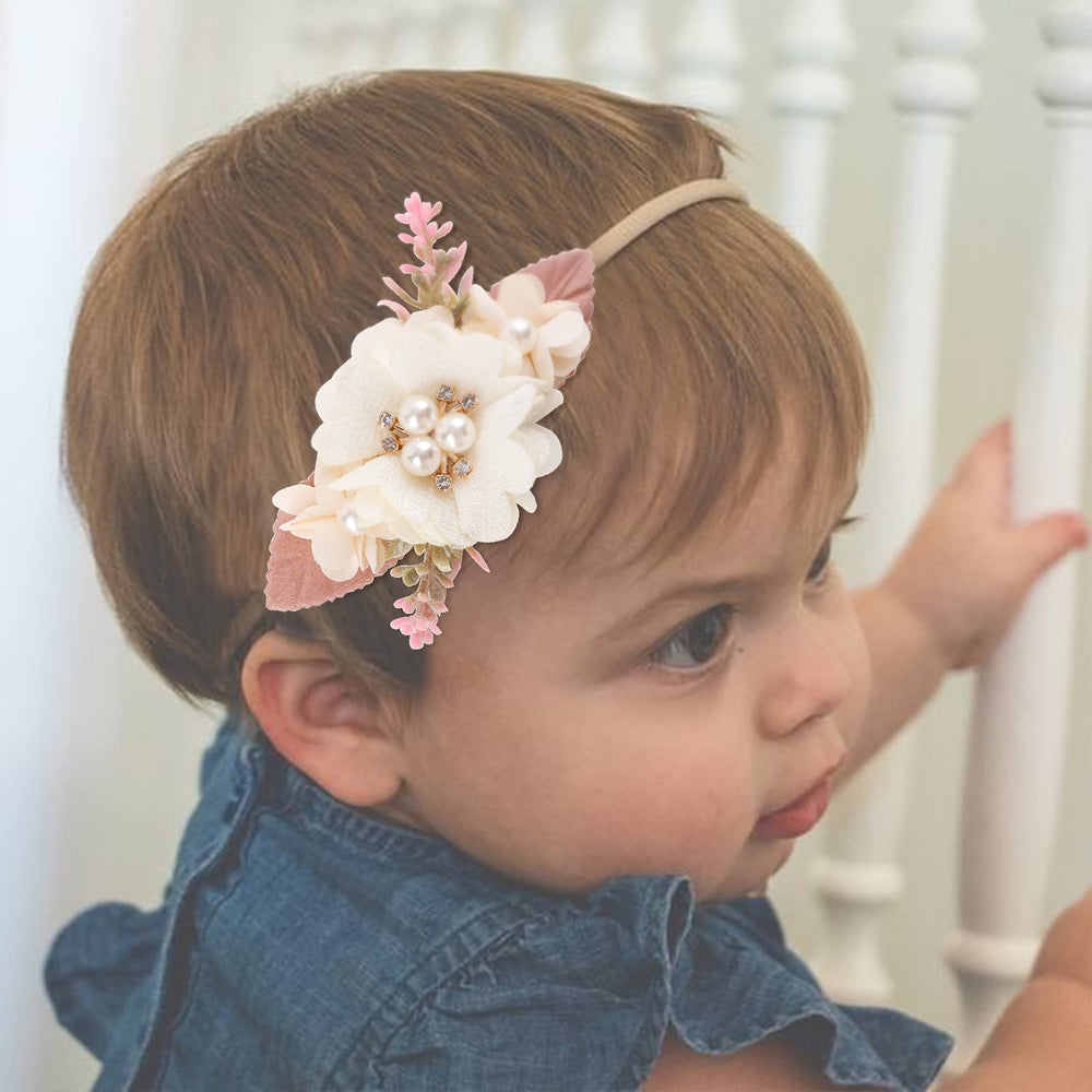 Cherrboll headbands on newborn baby during a photo session