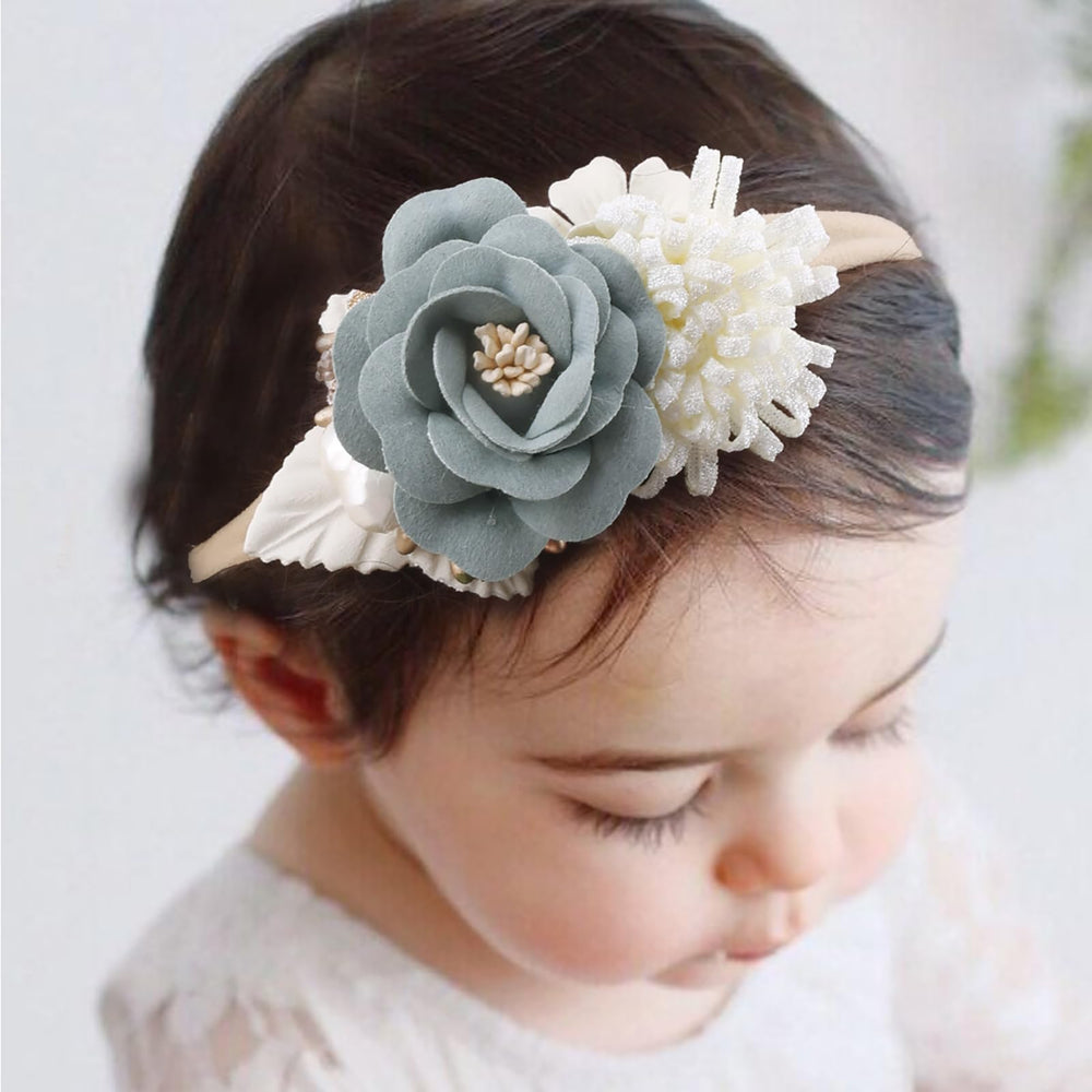 Newborn wearing a Cherrboll headband for a comfortable, non-restrictive fit.