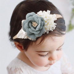 Newborn wearing a Cherrboll headband for a comfortable, non-restrictive fit.