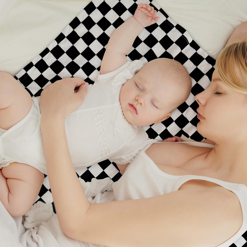 Civarua Kids checkered blanket wrapped around an infant for cozy swaddling.