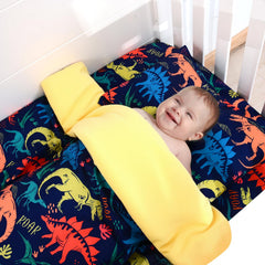 Cloele dinosaur-theme nursery decor enhances playful navy nursery design.