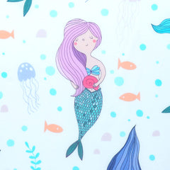 Close-up of soft, breathable polyester fabric from Cloele Mermaids crib sheet.