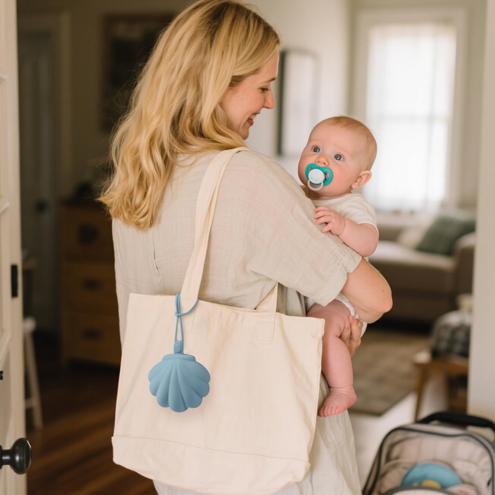 CLYMENE pacifier holder with strap attachment keeps essentials within reach for stroller trips.