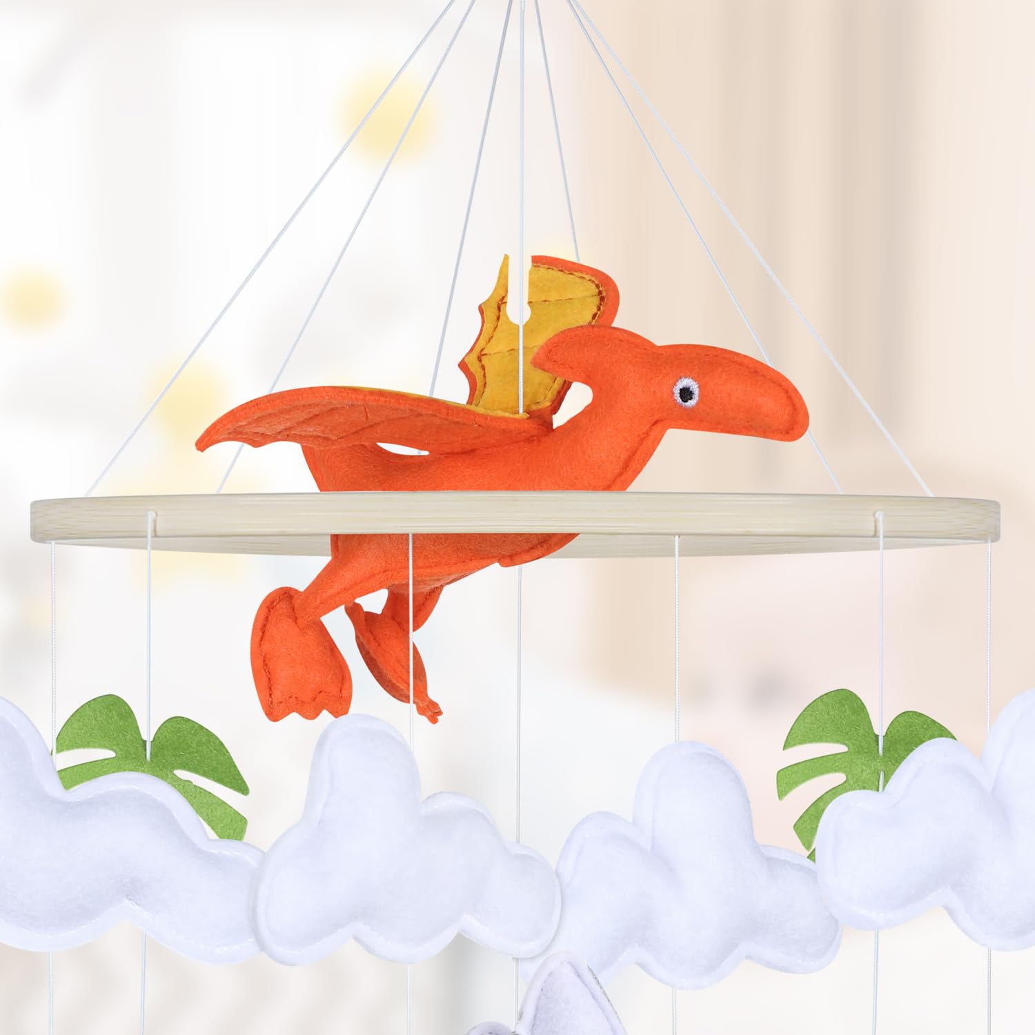 CLYMENE soft hypoallergenic dino mobile provides safe, cozy sensory play.