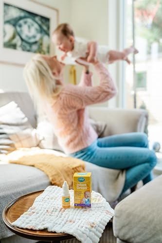 Colief Infant Drops drop releasing into milk to aid digestion.