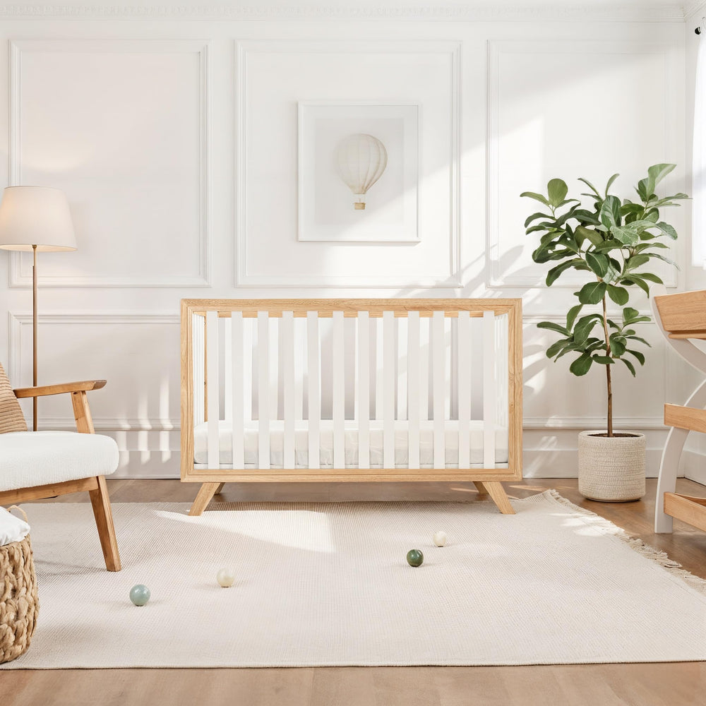 Adjustable mattress height feature on the Comfy Cubs crib for growing baby