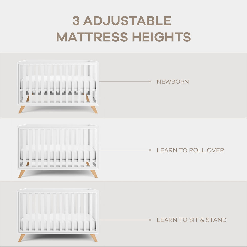 Comfy Cubs crib in white bars with natural wood legs complements decor.