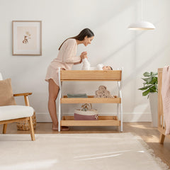 Comfy Cubs changing table with shelves keeps diapers and wipes within reach