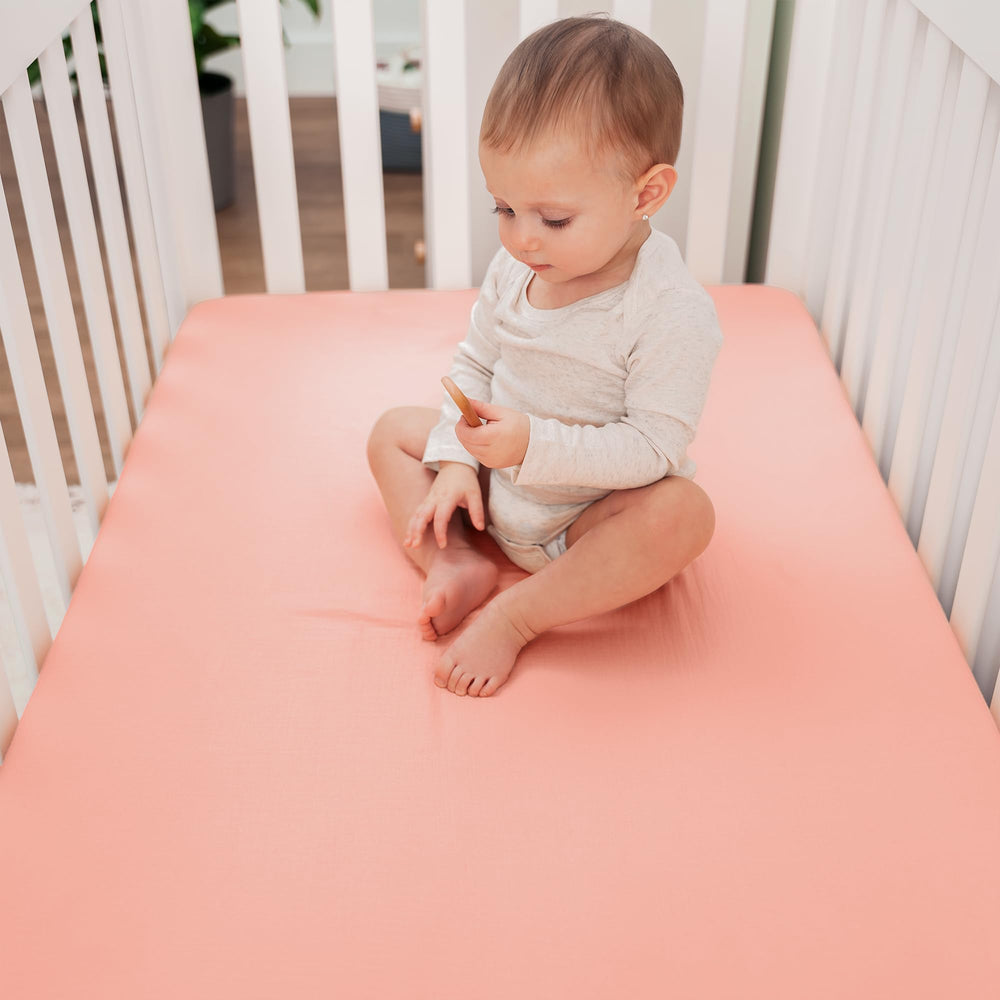Comfy Cubs Muslin crib sheet closeup highlights durable, machine washable fabric.