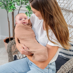 Comfy Cubs muslin wrap in Cedar supports tummy time and cozy play.