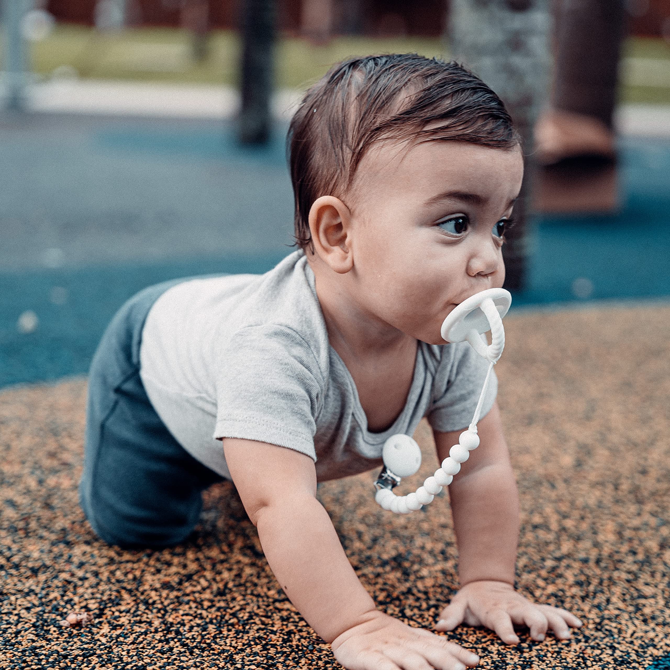 Comfy Cubs pacifier clips show soft colors on baby clothes for stylish practicality.
