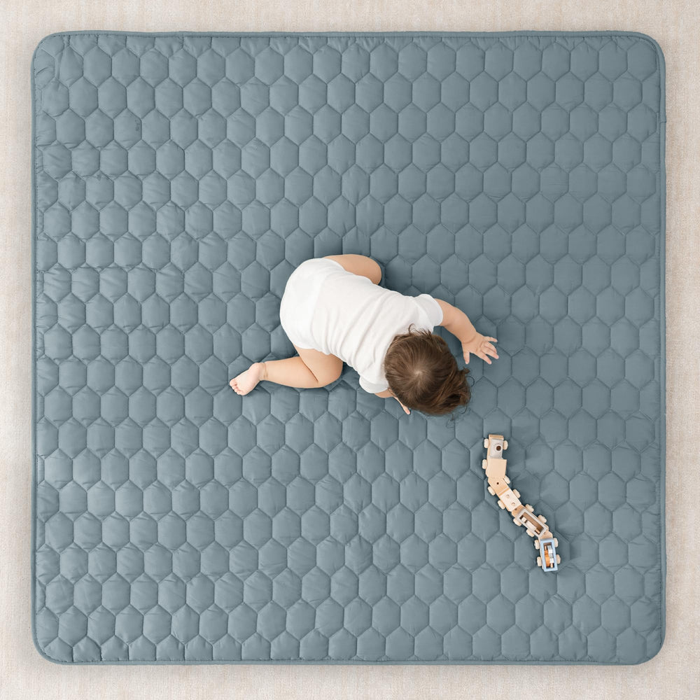 Comfy Cubs quilted-top mat adds extra padding for comfy crawls.