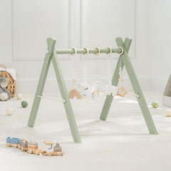 Comfy Cubs wooden baby play gym in natural finish promotes safe tummy time and exploration.