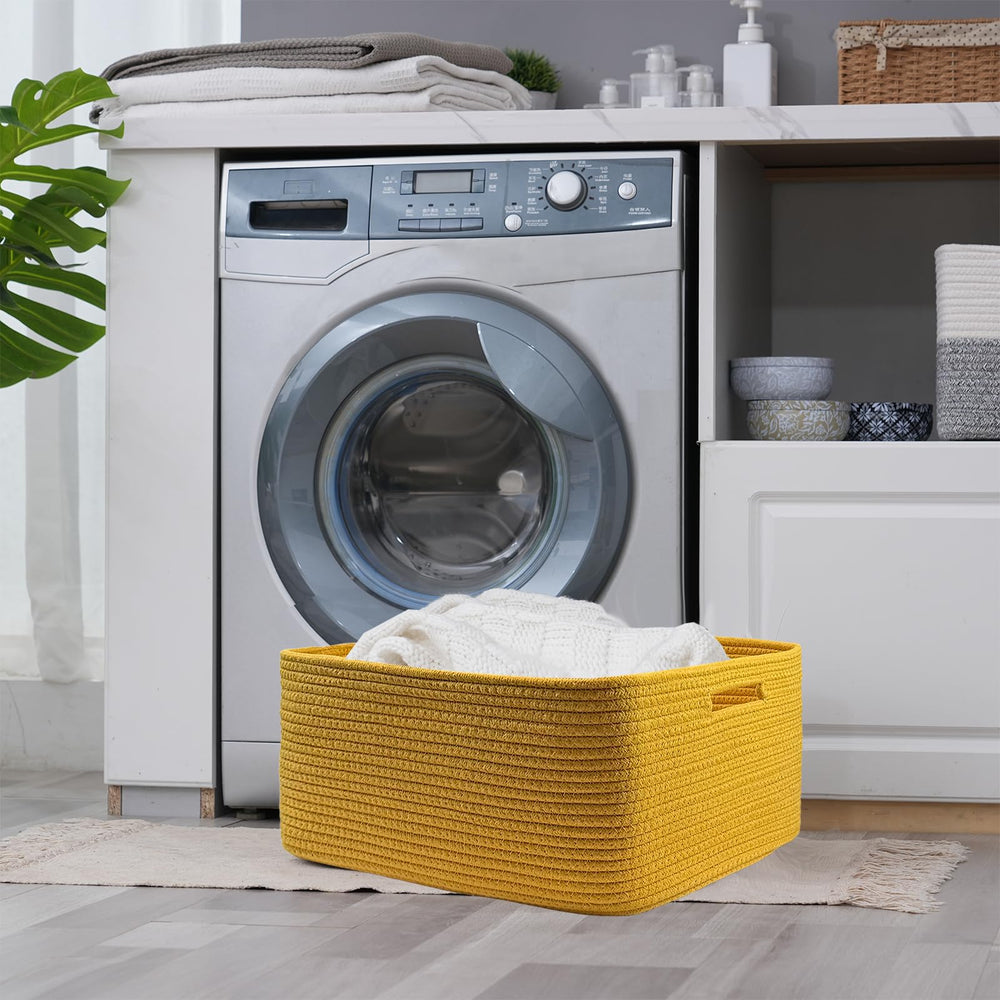 COMFY-HOMI laundry basket in yellow stores blankets and towels.