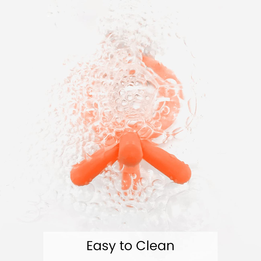 Comotomo orange teether pictured for travel and stroller use.