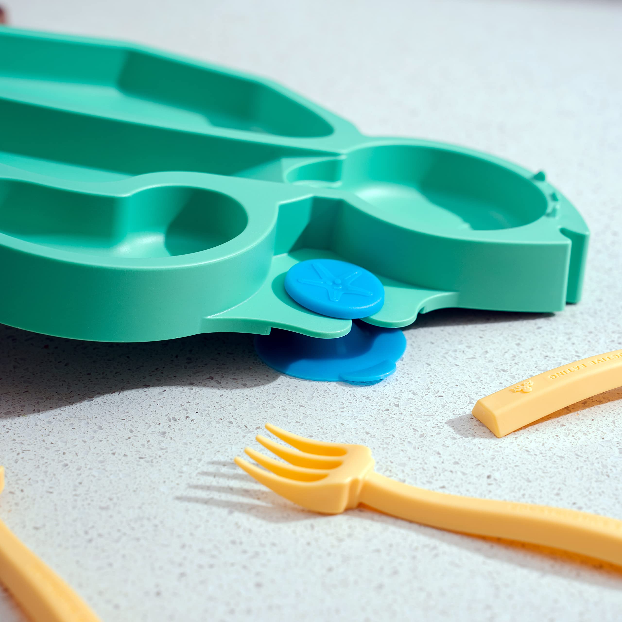 Constructive Eating suction base plate shown securing to a high chair.