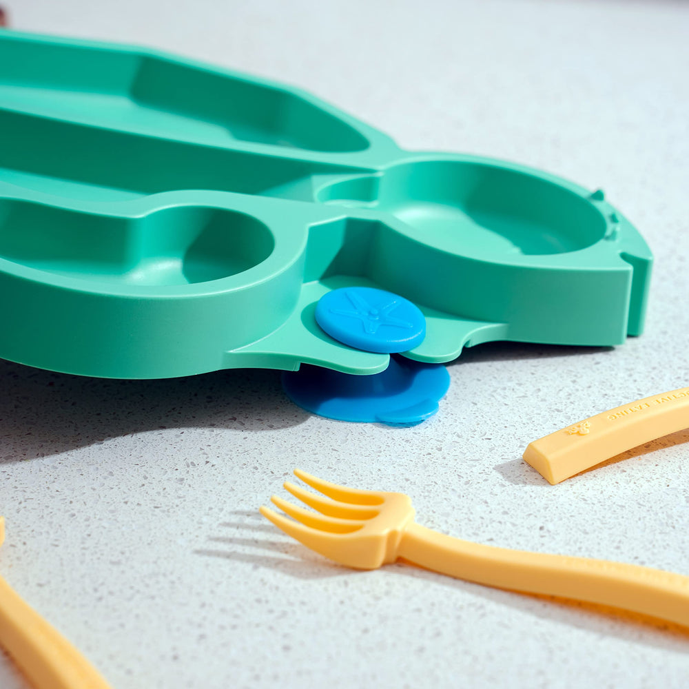 Constructive Eating suction base plate shown securing to a high chair.